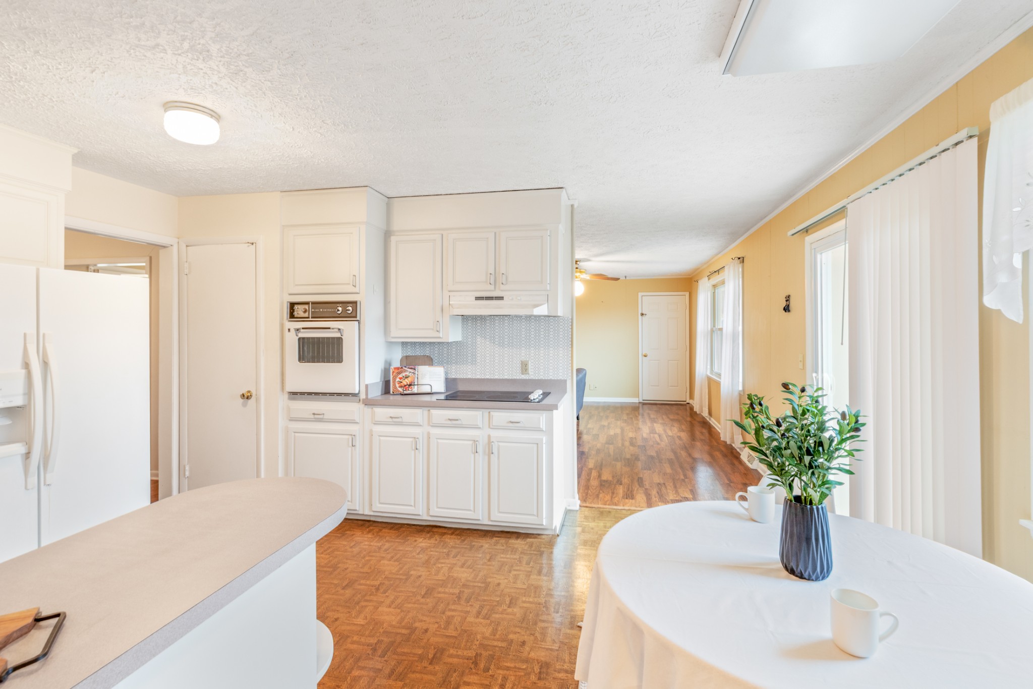 2054 Ridgecrest Circle Dickson, TN 37055 - Photo 15 of 38 a kitchen with stainless steel appliances a white table chairs and a refrigerator