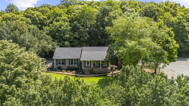 a view of house with yard and sitting area