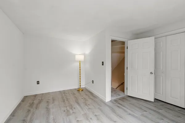 a view of a room that has wooden floor and windows in it