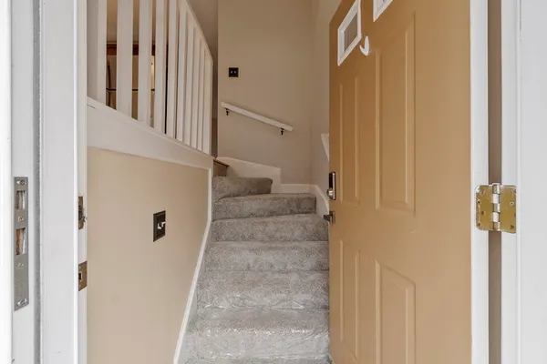 a view of staircase with white walls