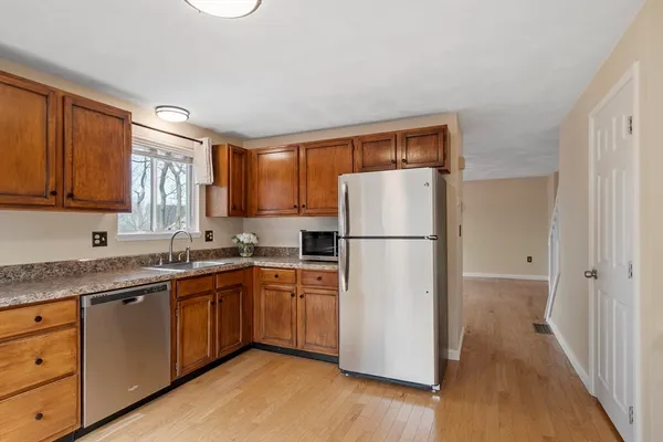 a kitchen with appliances a sink and a window