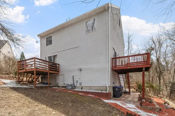 a view of a house with a yard and covered with snow in the background