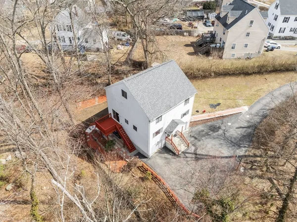 an aerial view of a house with a yard