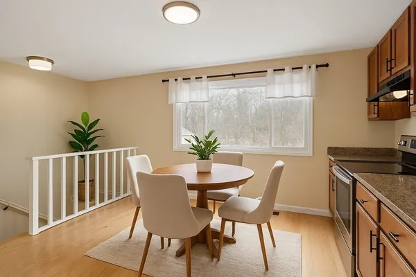 a dining room with furniture and wooden floor