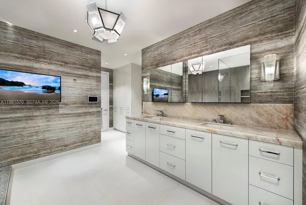 a large kitchen with granite countertop a large window and cabinets