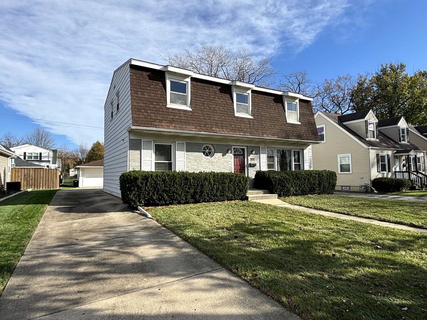 991 Spring Road Elmhurst, IL 60126 - Photo 2 of 17 a front view of a house with a yard