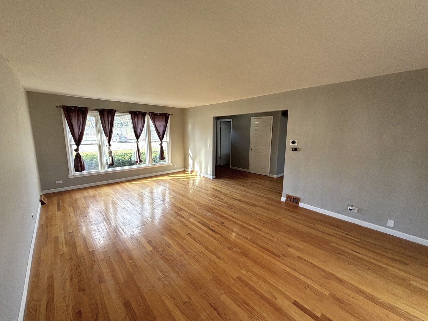 991 Spring Road Elmhurst, IL 60126 - Photo 3 of 17 wooden floor in an empty room with a window