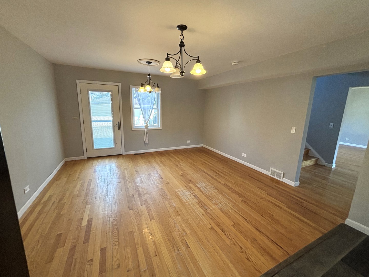 991 Spring Road Elmhurst, IL 60126 - Photo 6 of 17 wooden floor in an empty room with a window