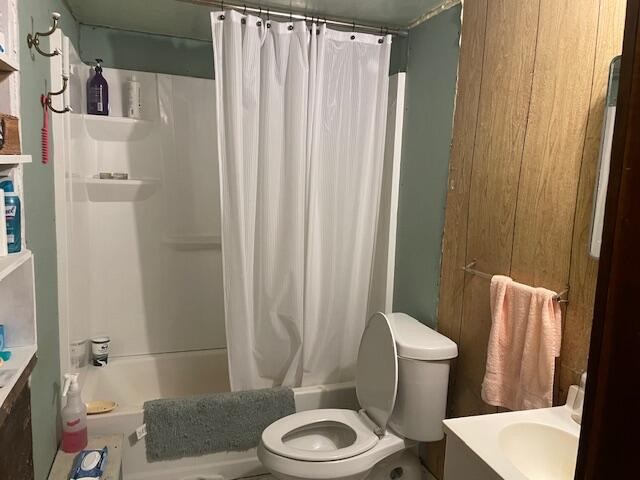 704 Annadel Road Lancing, TN 37770 - Photo 42 of 51 a white toilet sitting next to a bathroom sink and tub