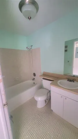 a bathroom with a sink a toilet and bathtub