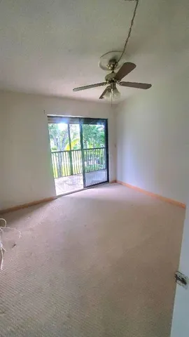 a view of a livingroom with a ceiling fan and window