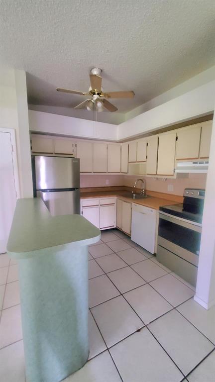 9731 West McNab Road, Unit 208 Fort Lauderdale, FL 33321 - Photo 25 of 31 a kitchen with stainless steel appliances granite countertop a sink and cabinets