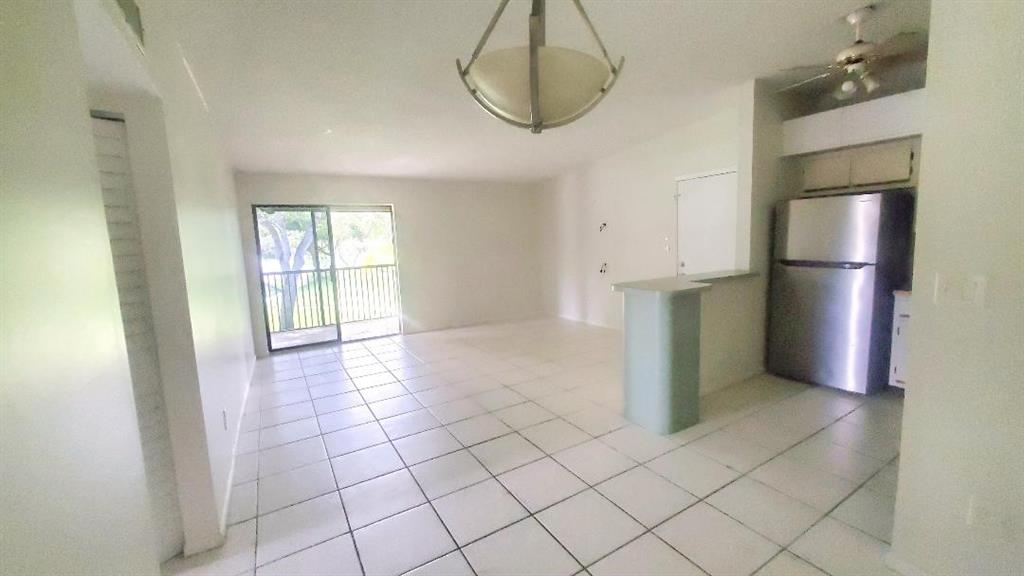 9731 West McNab Road, Unit 208 Fort Lauderdale, FL 33321 - Photo 27 of 31 a view of kitchen with furniture and refrigerator