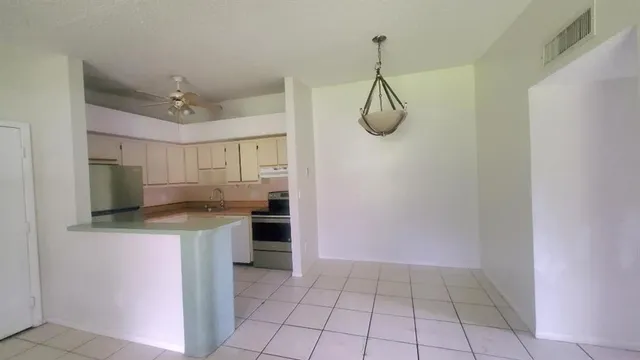 a kitchen with a counter top space cabinets and stainless steel appliances