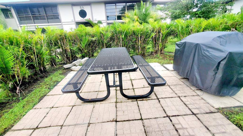 9731 West McNab Road, Unit 208 Fort Lauderdale, FL 33321 - Photo 3 of 31 a view of backyard with plants and outdoor seating