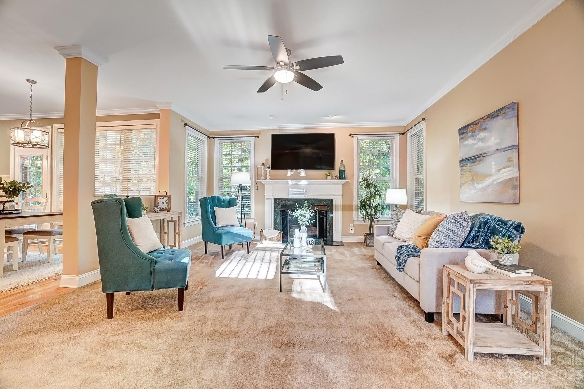 9710 Shadowmere Lane Weddington, NC 28104 - Photo 11 of 46 a living room with furniture a fireplace and a flat screen tv