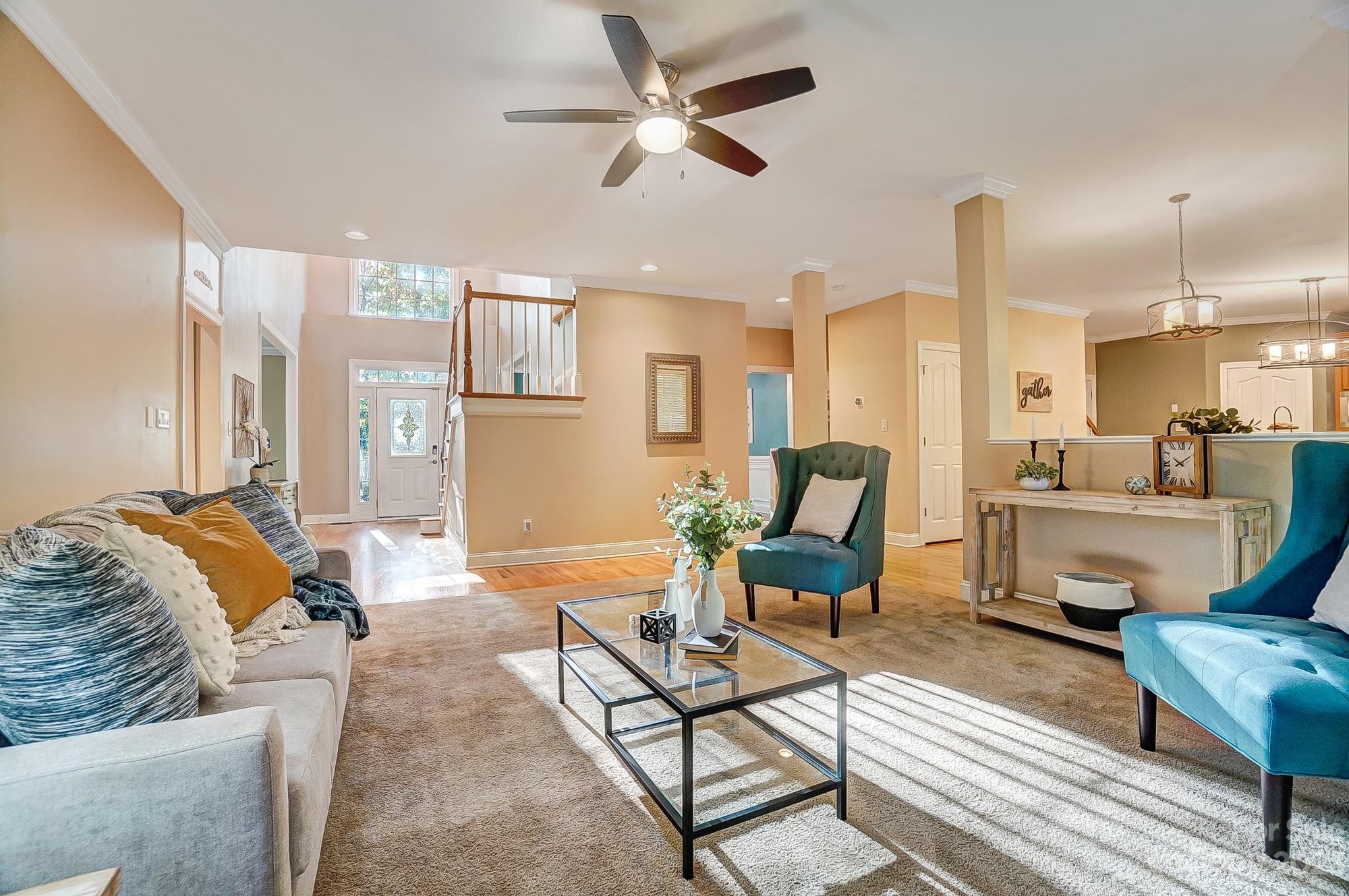 9710 Shadowmere Lane Weddington, NC 28104 - Photo 12 of 46 a living room with furniture and a chandelier