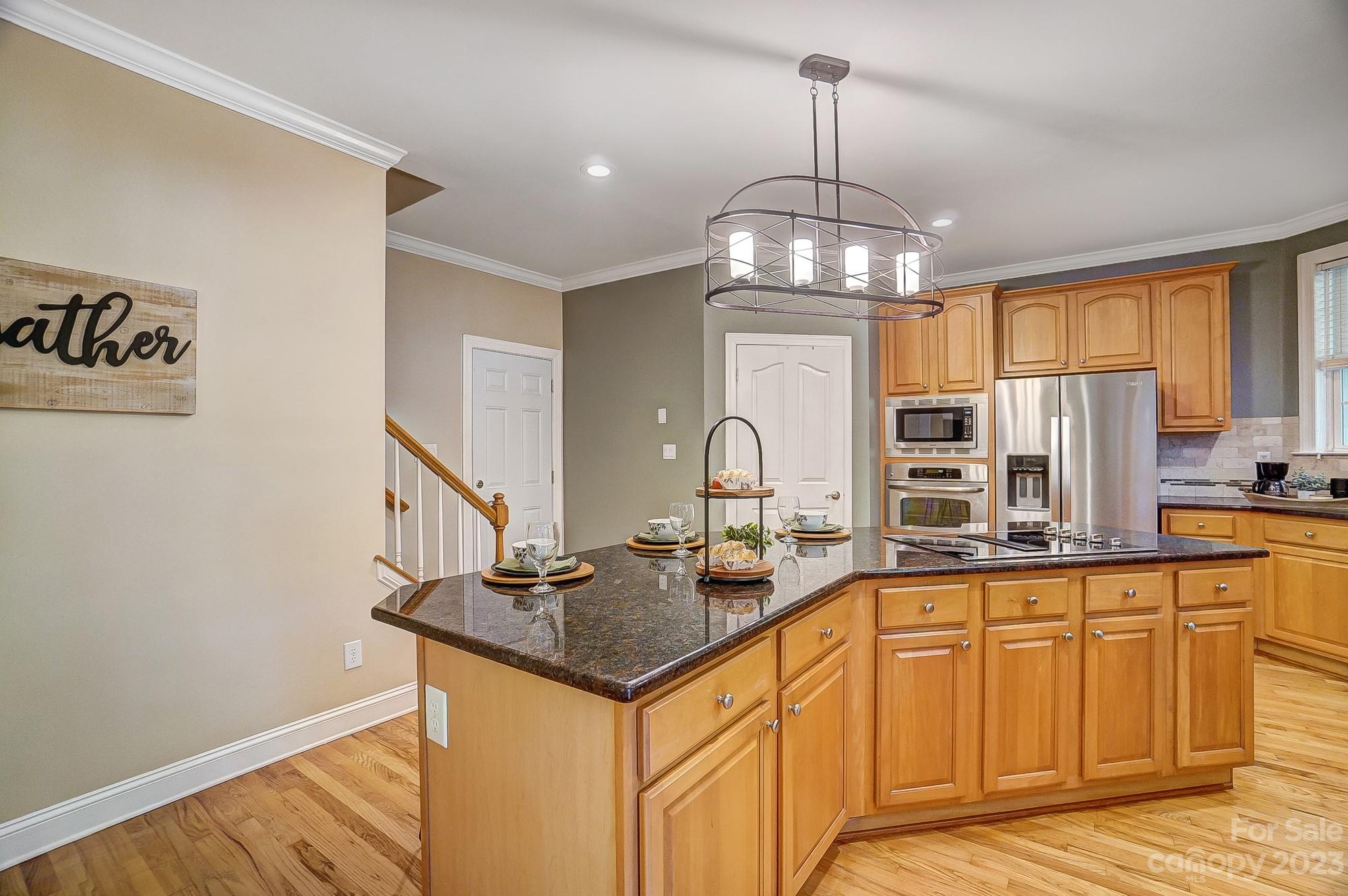 9710 Shadowmere Lane Weddington, NC 28104 - Photo 18 of 46 a kitchen with stainless steel appliances granite countertop a sink stove and cabinets