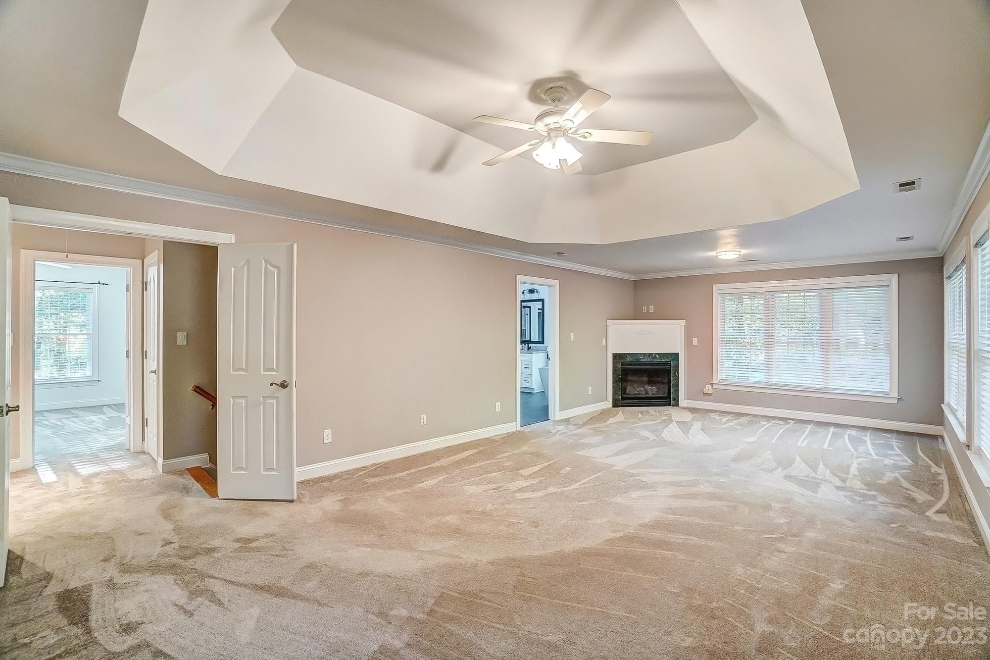 9710 Shadowmere Lane Weddington, NC 28104 - Photo 26 of 46 a view of an empty room with chandelier fan and fire place