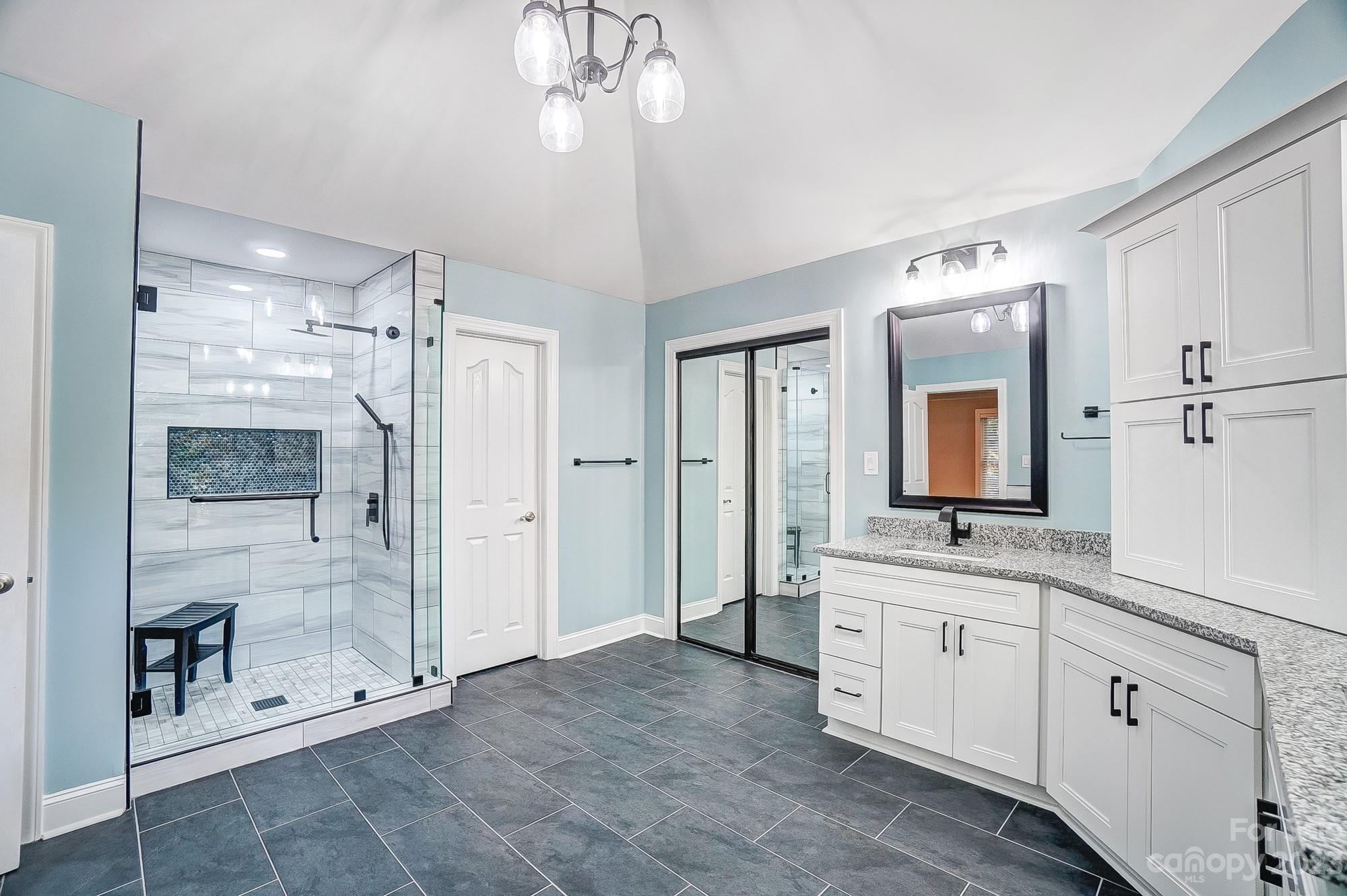 9710 Shadowmere Lane Weddington, NC 28104 - Photo 29 of 46 a spacious bathroom with a shower a sink and a mirror