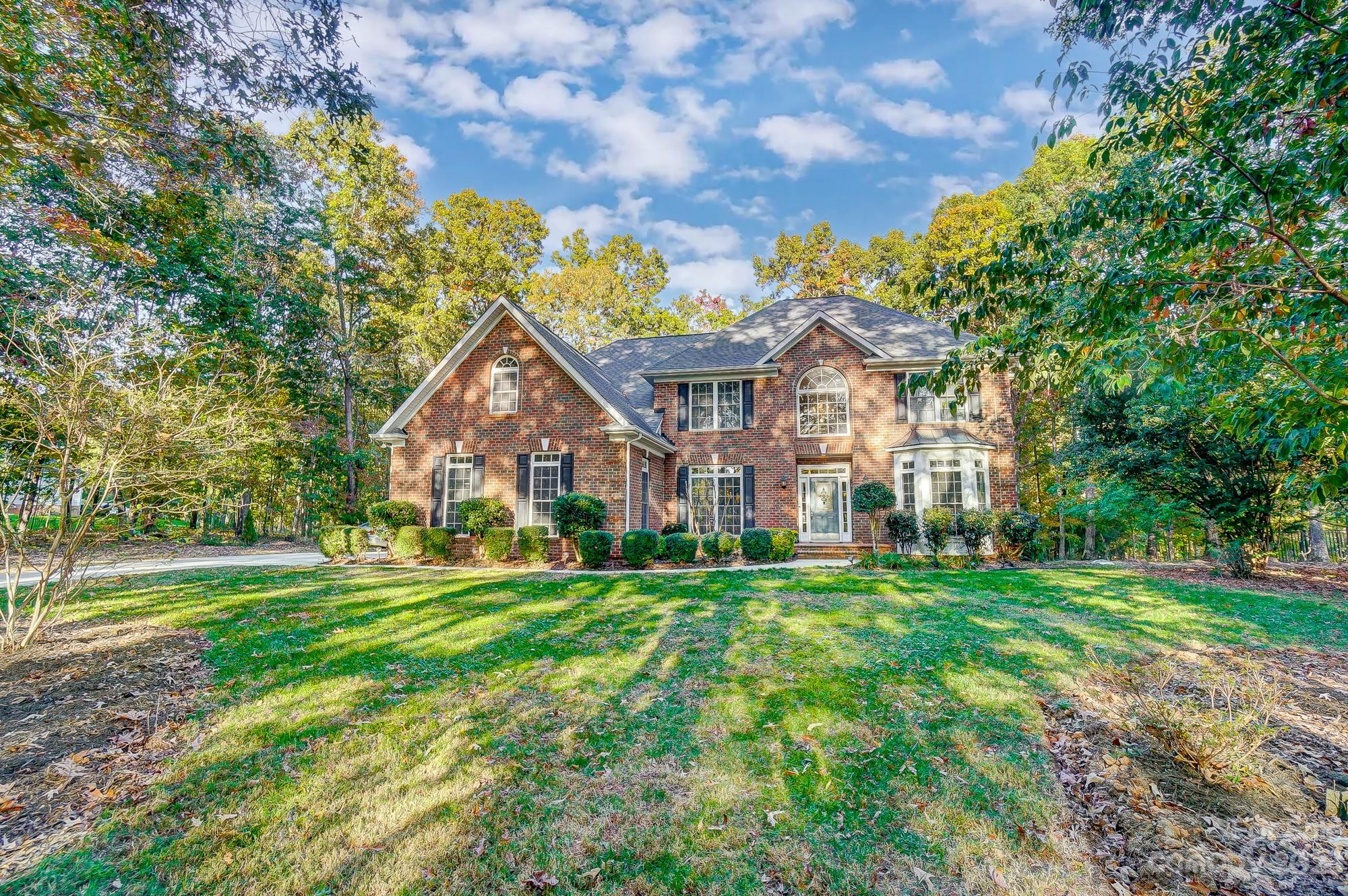 9710 Shadowmere Lane Weddington, NC 28104 - Photo 3 of 46 a front view of a house with a yard and trees
