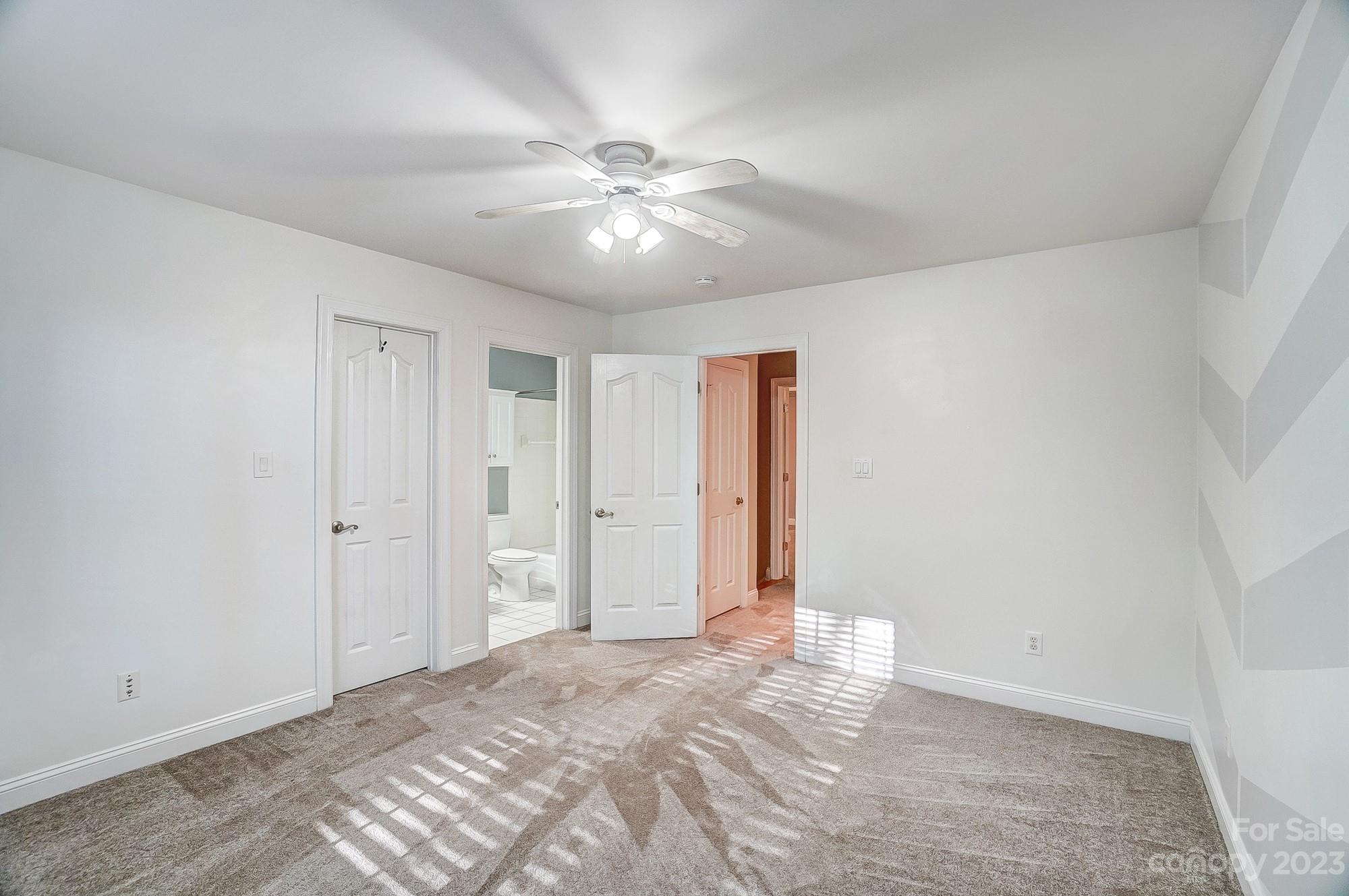 9710 Shadowmere Lane Weddington, NC 28104 - Photo 31 of 46 a view of an empty room with a ceiling fan and a window