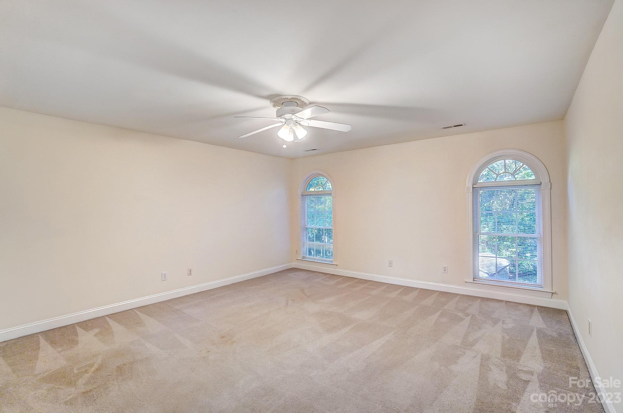 9710 Shadowmere Lane Weddington, NC 28104 - Photo 33 of 46 an empty room with windows and fan