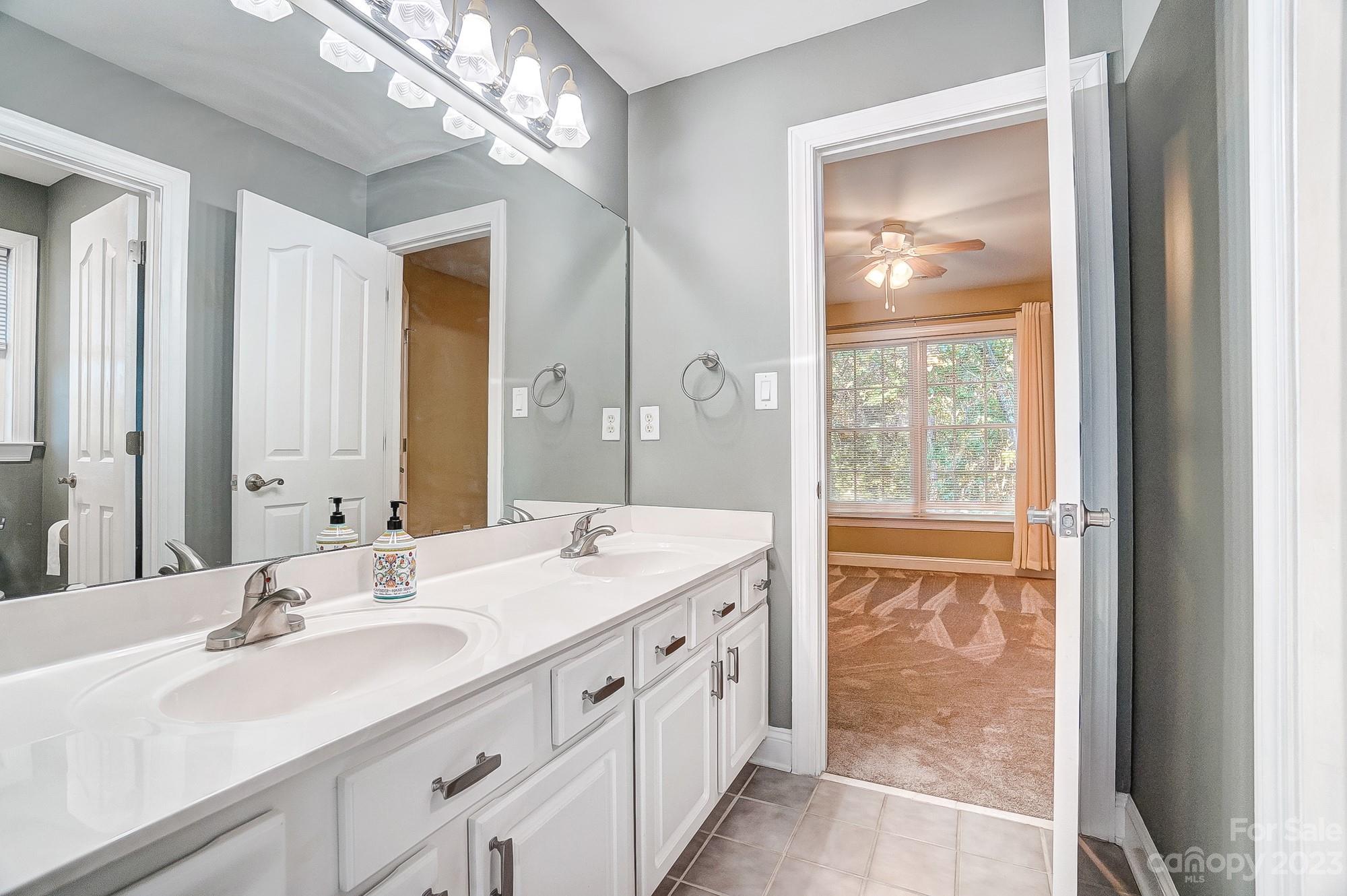 9710 Shadowmere Lane Weddington, NC 28104 - Photo 37 of 46 a bathroom with double vanity sinks and a mirror