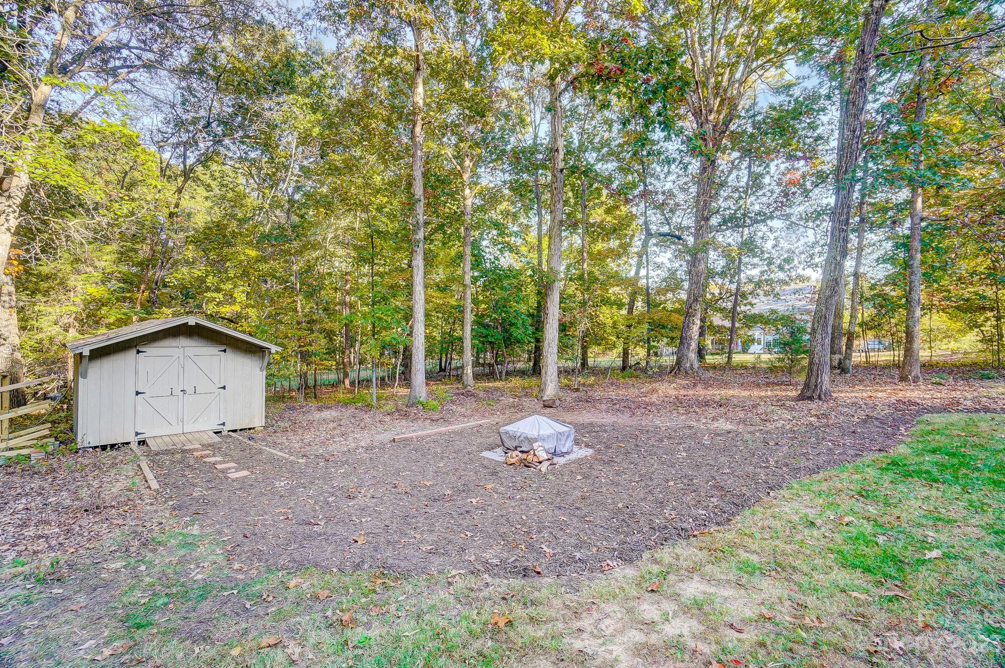 9710 Shadowmere Lane Weddington, NC 28104 - Photo 45 of 46 a view of a house with large trees and a forest