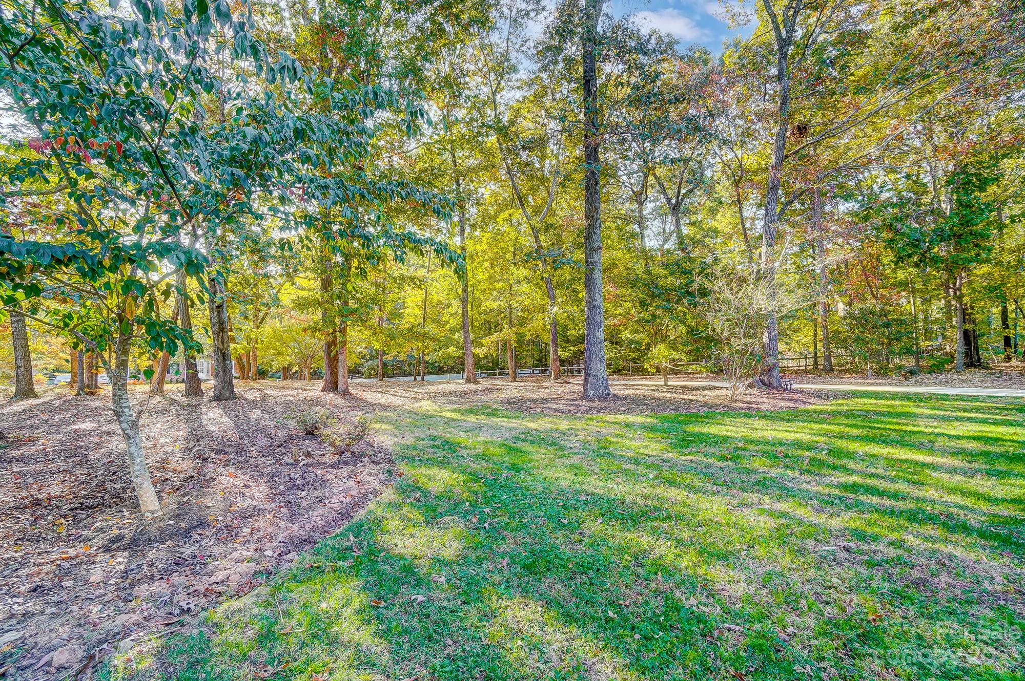 9710 Shadowmere Lane Weddington, NC 28104 - Photo 5 of 46 a view of outdoor space with trees all around