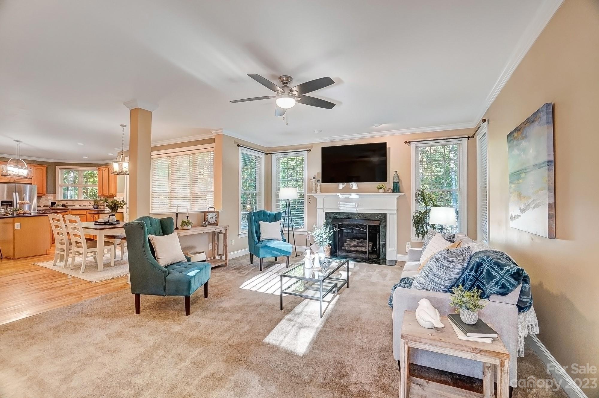 9710 Shadowmere Lane Weddington, NC 28104 - Photo 10 of 46 a living room with furniture a fireplace and a flat screen tv