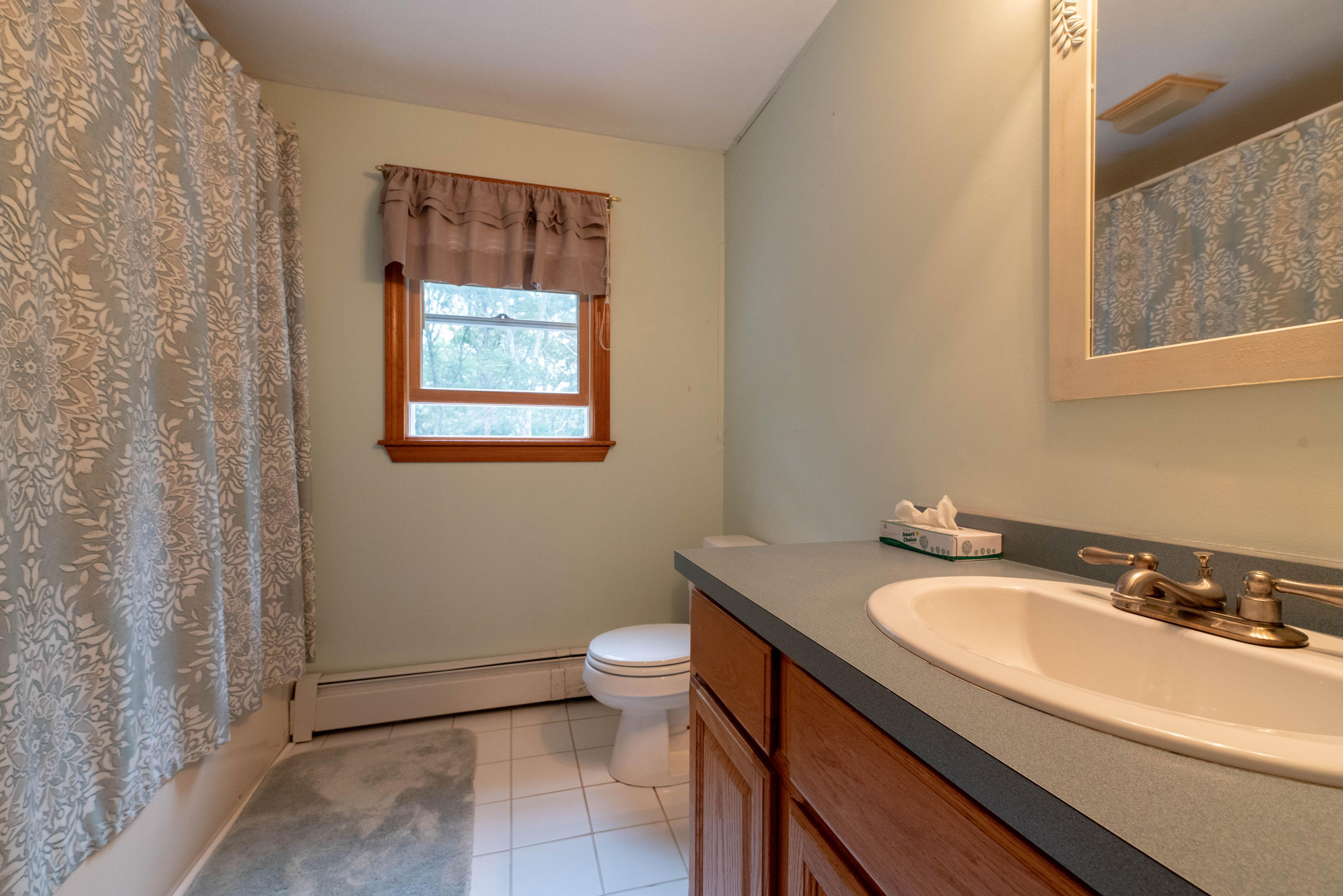 187 James Circle Mashpee, MA 02649 - Photo 16 of 23 a bathroom with a granite countertop sink and a mirror