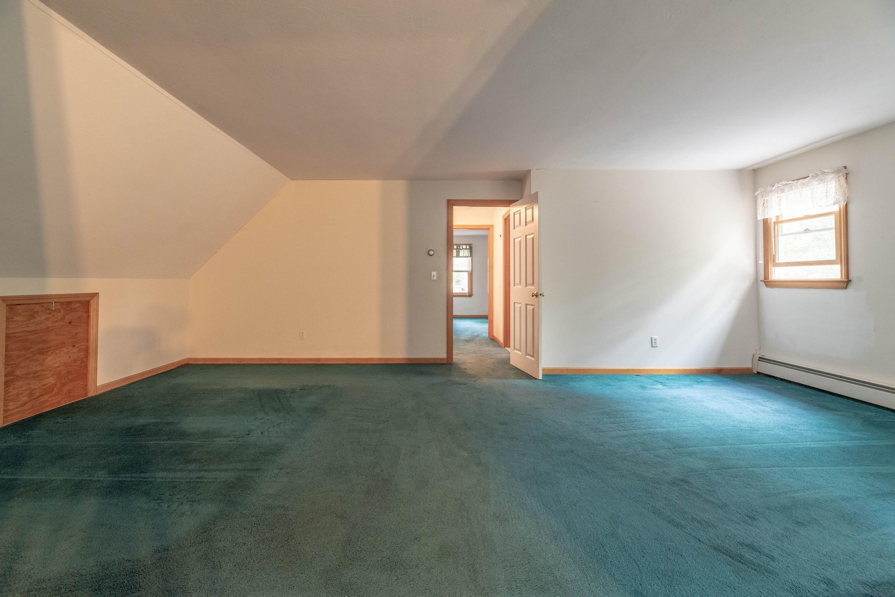 187 James Circle Mashpee, MA 02649 - Photo 22 of 23 a view of an empty room with window and wooden floor