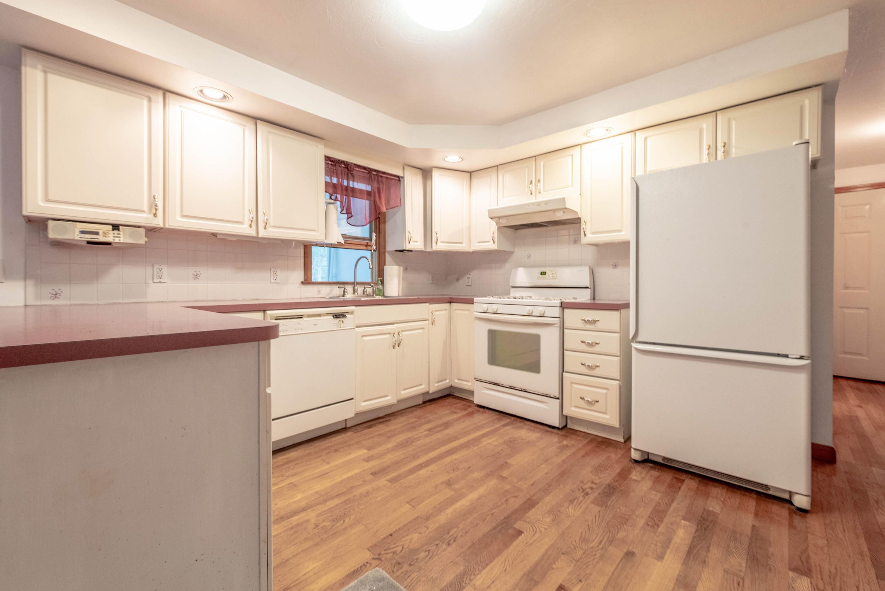 187 James Circle Mashpee, MA 02649 - Photo 7 of 23 a kitchen with white cabinets sink and white appliances