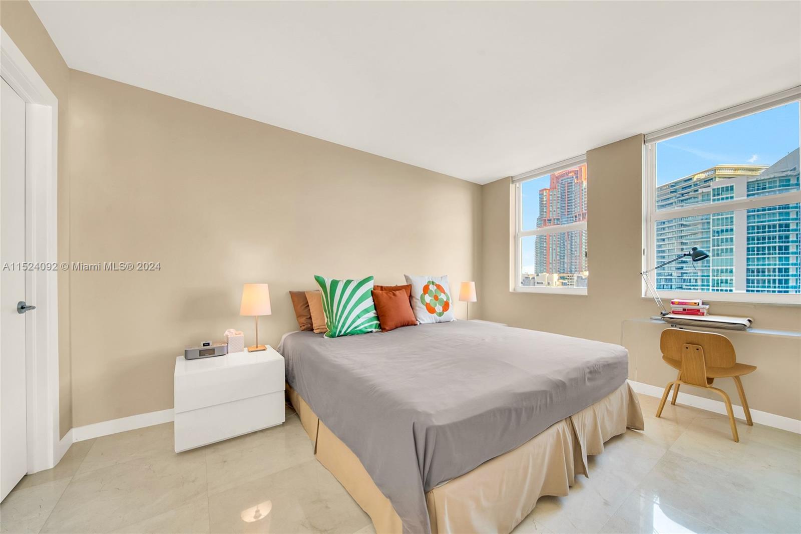 90 Alton Road, Unit 902 Miami Beach, FL 33139 - Photo 11 of 35 a bedroom with a bed and a large window