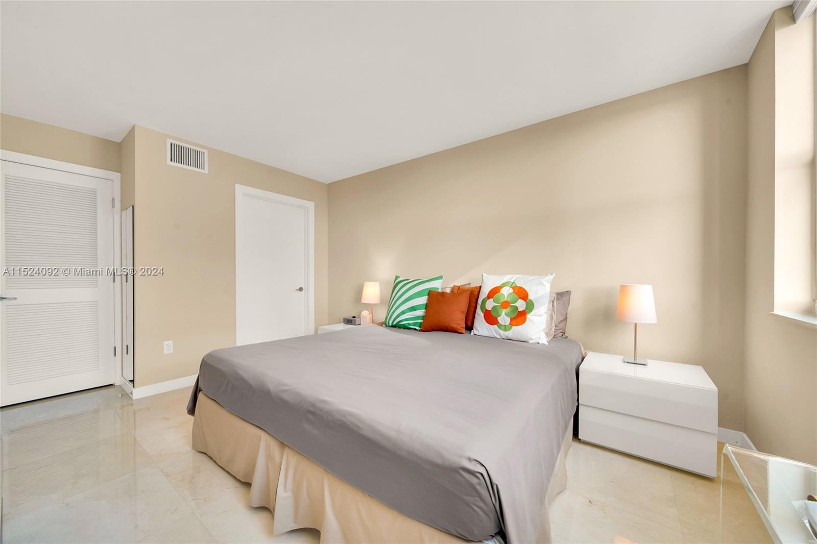 90 Alton Road, Unit 902 Miami Beach, FL 33139 - Photo 12 of 35 a bedroom with a bed and a couch