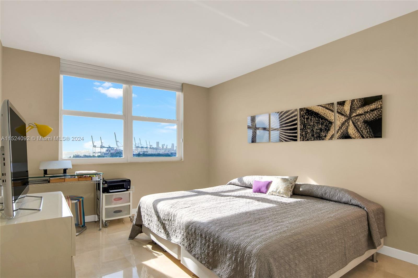 90 Alton Road, Unit 902 Miami Beach, FL 33139 - Photo 21 of 35 a bedroom with a bed and wooden floor