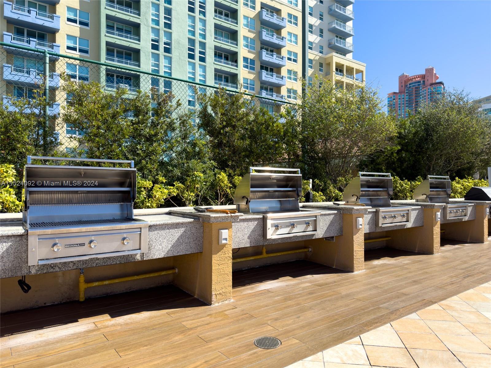 90 Alton Road, Unit 902 Miami Beach, FL 33139 - Photo 29 of 35 a kitchen with stainless steel appliances and trees