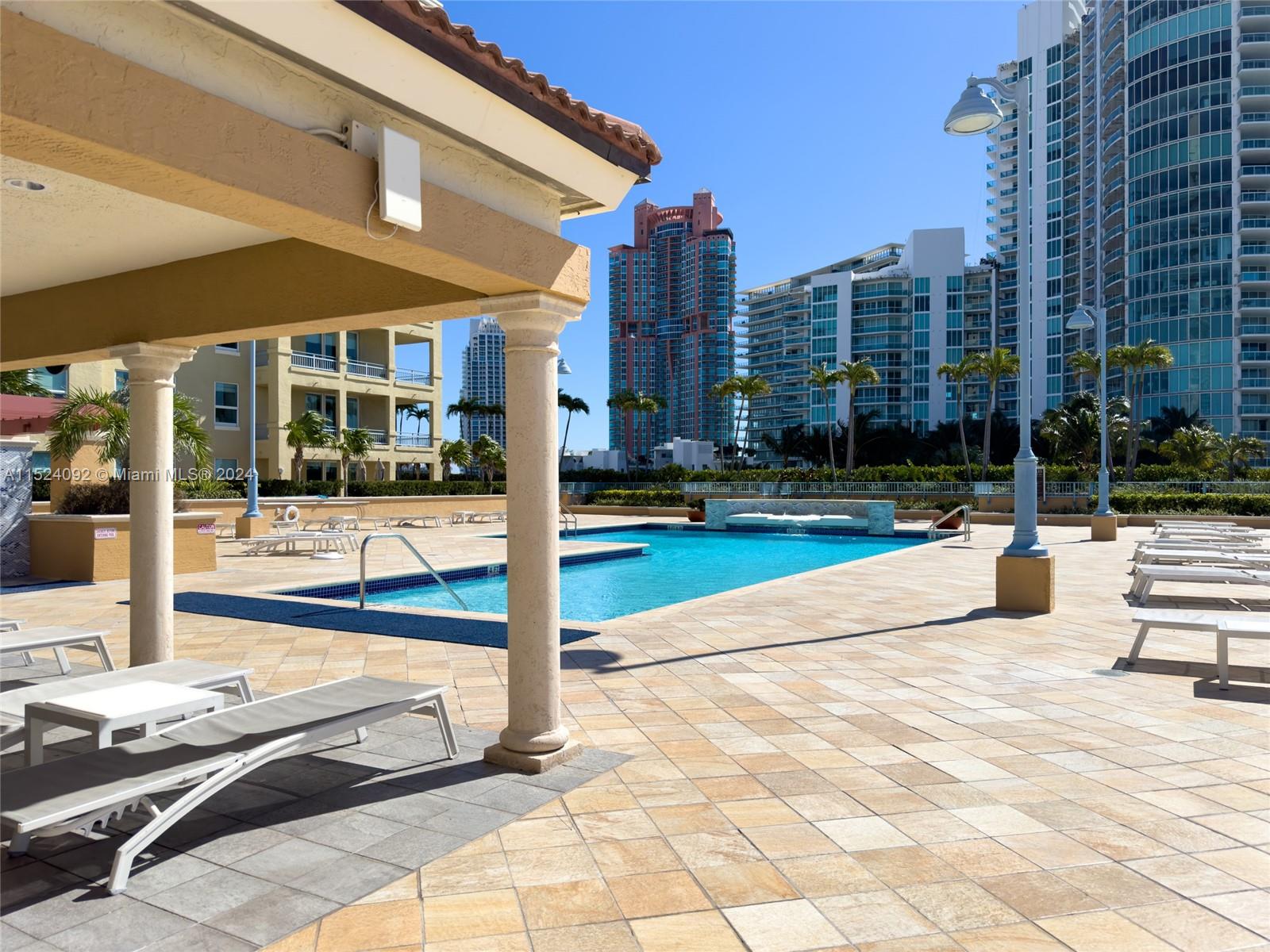90 Alton Road, Unit 902 Miami Beach, FL 33139 - Photo 30 of 35 a view of a patio with a bench