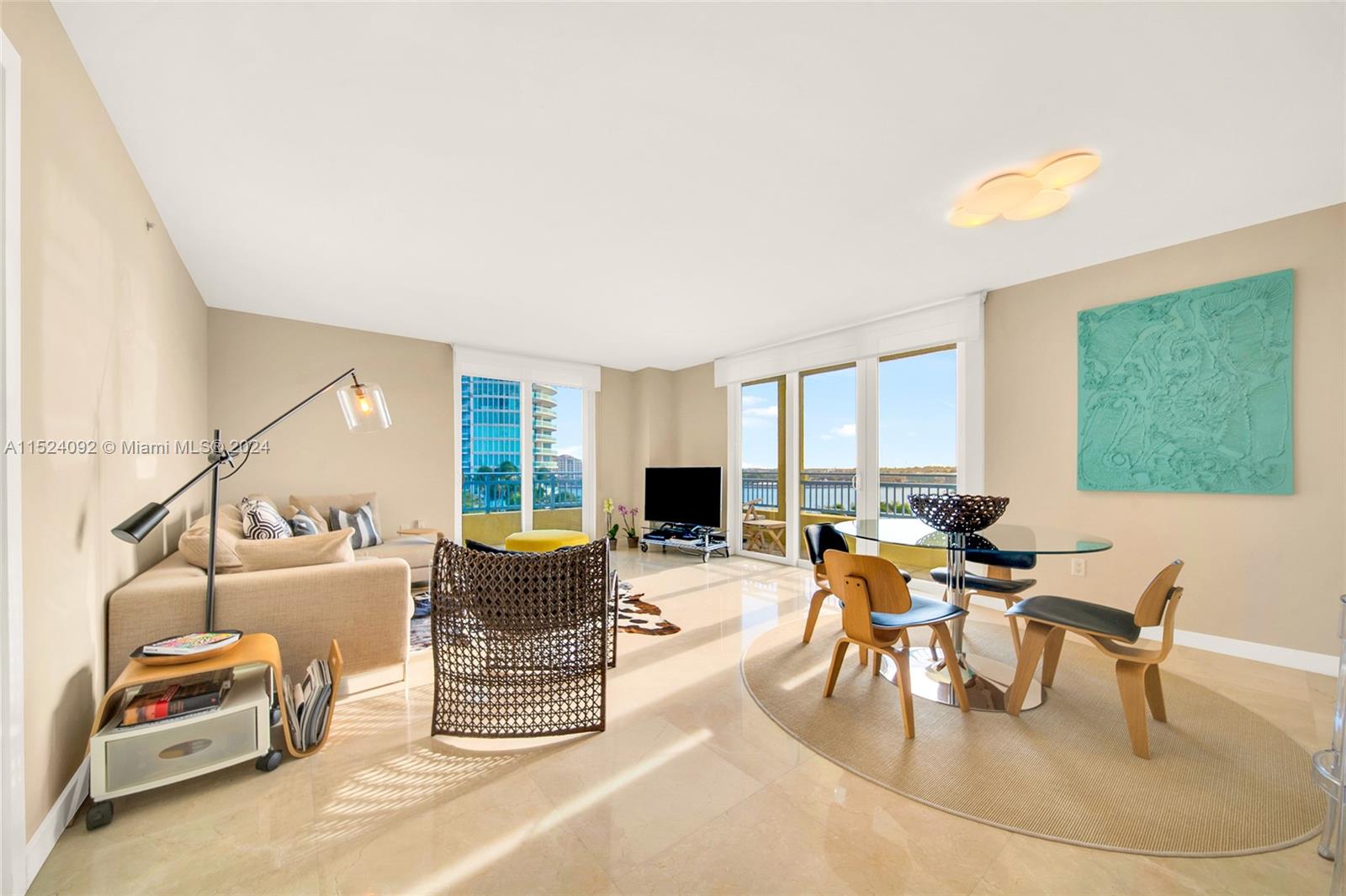 90 Alton Road, Unit 902 Miami Beach, FL 33139 - Photo 5 of 35 a living room with furniture and a flat screen tv