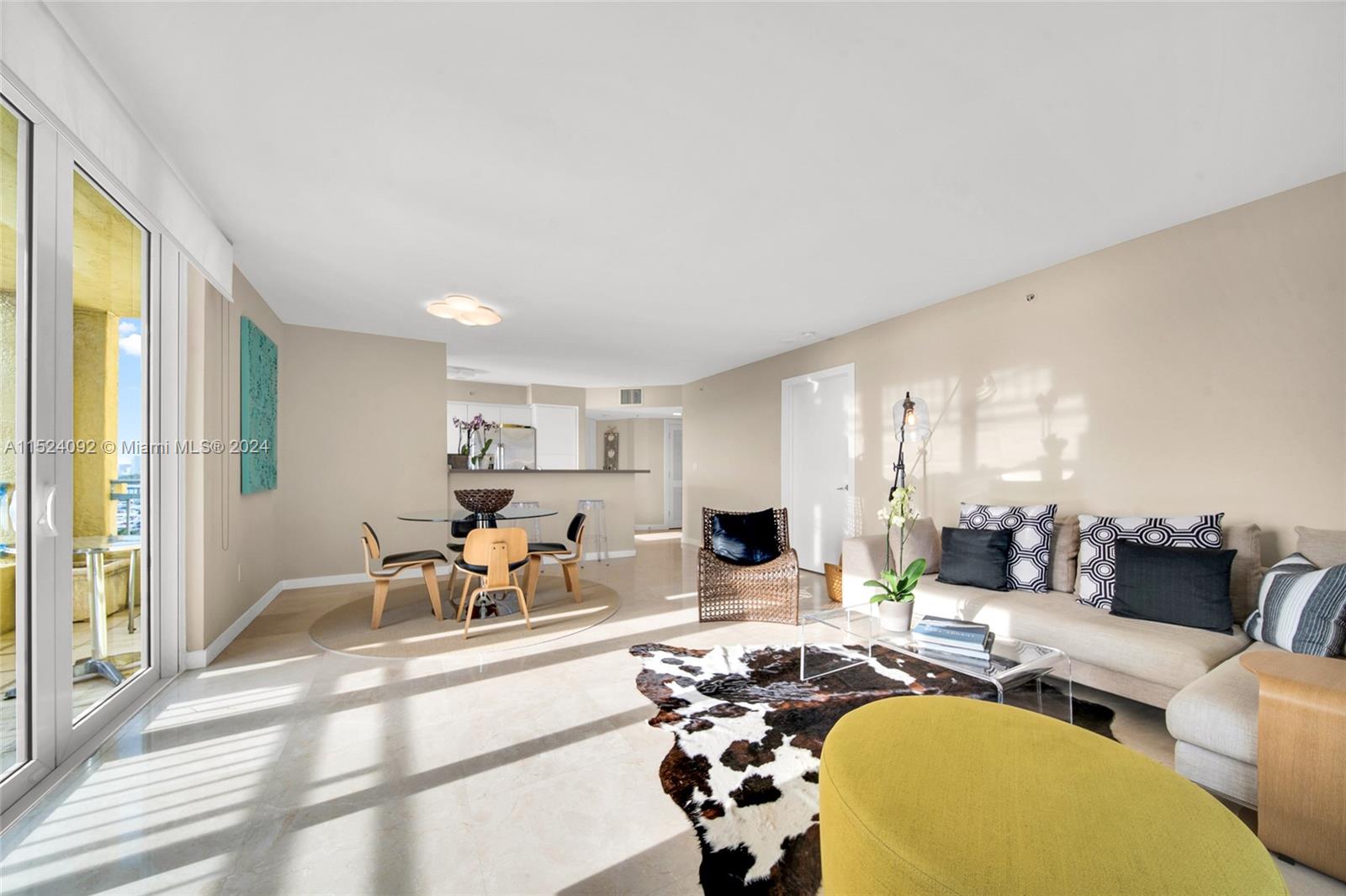 90 Alton Road, Unit 902 Miami Beach, FL 33139 - Photo 6 of 35 a living room with furniture and a table