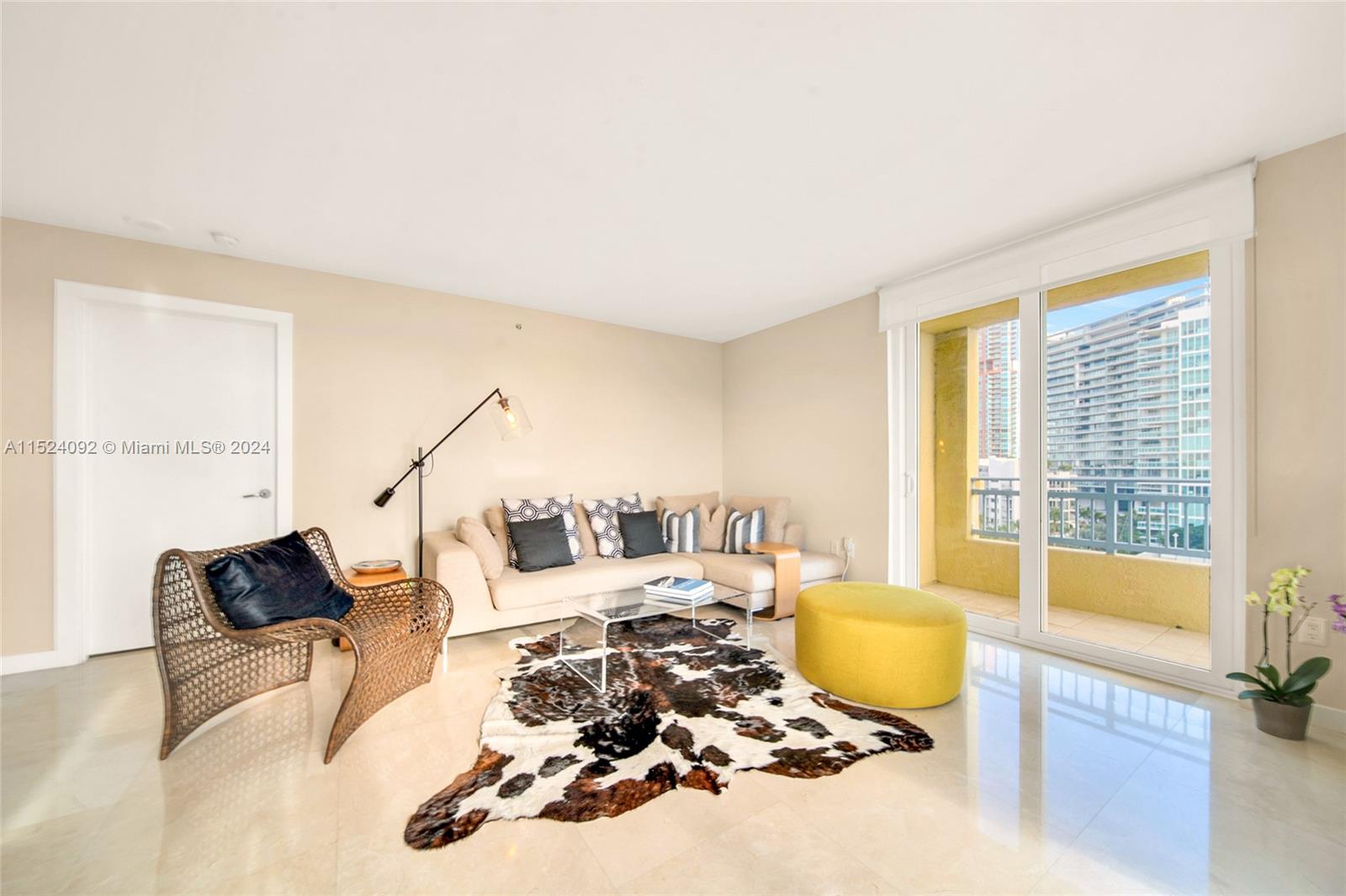 90 Alton Road, Unit 902 Miami Beach, FL 33139 - Photo 8 of 35 a living room with furniture and a large window