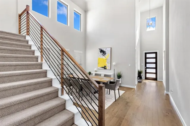 a view of entryway and hall with wooden floor