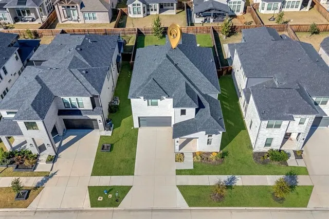 an aerial view of multiple houses with a yard
