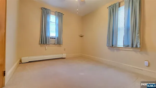 an empty room with windows and closet