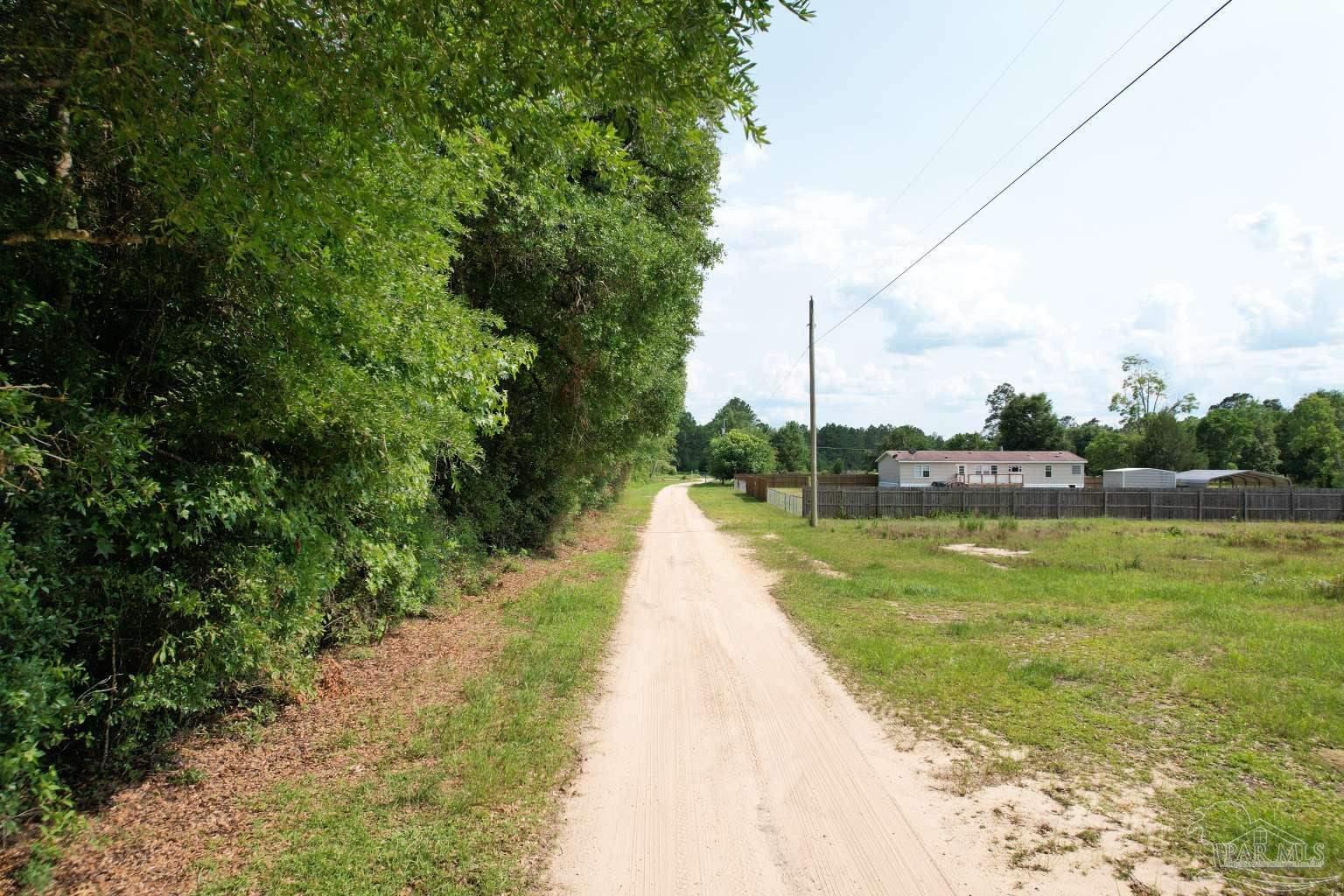 400 Brown Road McDavid, FL 32568 - Photo 5 of 10 a view of a lake with a big yard
