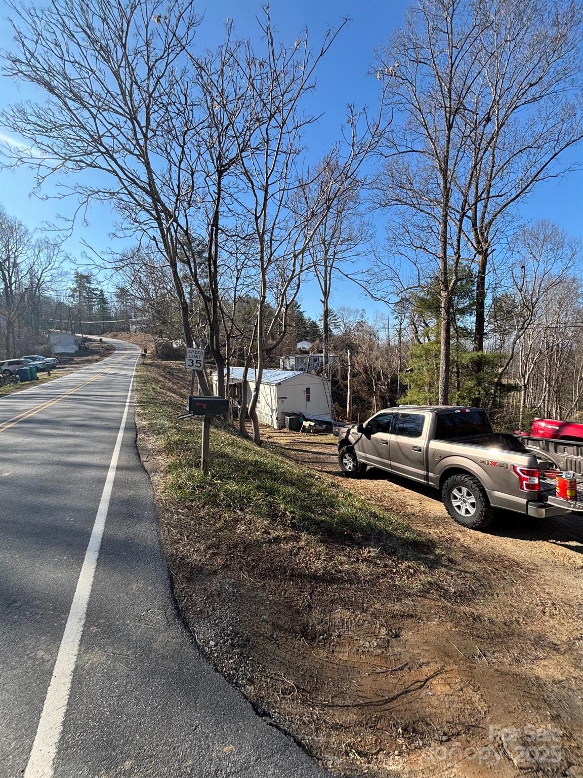 905 Hutch Mountain Road Fletcher, NC 28732 - Photo 3 of 9 a view of a street with a large tree