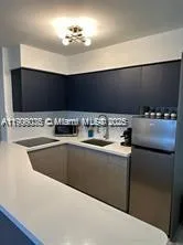 a kitchen with a sink cabinets and appliances