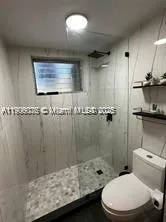 a bathroom with a toilet a sink and shower