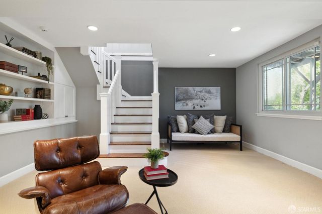 a living room with furniture and a painting